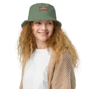 Smiling curly-haired woman in green bucket hat